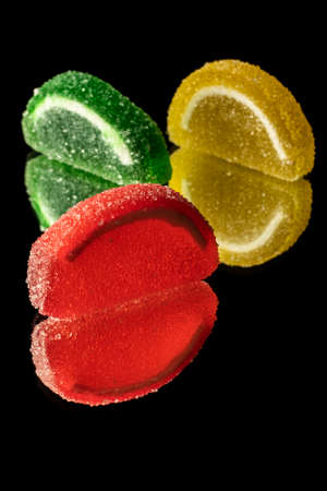 close-up black background mixed color fruit flavored sweet soft candyの写真素材