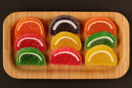 close-up black background mixed color fruit flavored sweet soft candy