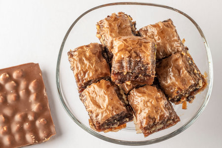 Turkish dessert baklava with chocolate and walnuts in a crispy plate close-upの写真素材