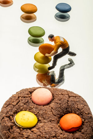 close-up studio colorful bonbon sugar cookies and miniature model concept
