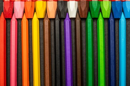 close-up of colored pastel crayons on a black background