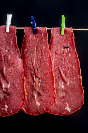 Close-up detail studio red meat sliced lined up fenugreek stripped local kayseri ribeye baconの写真素材