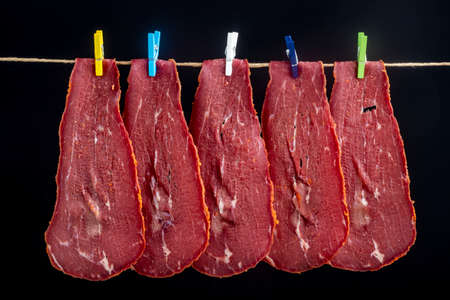 Close-up detail studio red meat sliced lined up fenugreek stripped local kayseri ribeye baconの写真素材