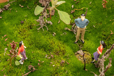 park garden landscaping concept with close-up miniature human figuresの写真素材