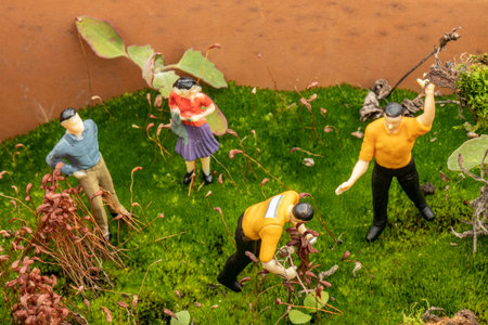 park garden landscaping concept with close-up miniature human figuresの写真素材