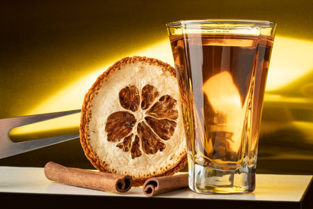 close-up shot glass with orange cinnamon flavor high alcohol tequila gold agaveの写真素材