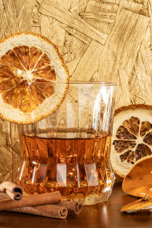 close-up shot glass with orange cinnamon flavor high alcohol tequila gold agaveの写真素材