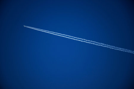 airplane and stern track in clear air blue sky