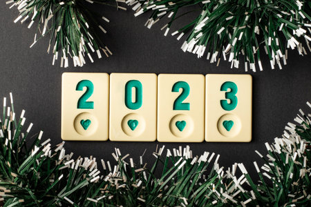 2023 new year concept with close-up black background christmas decorations and okey stonesの写真素材