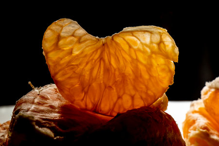 close-up detail black ground peeled tangerine organic vitamin fruitの写真素材