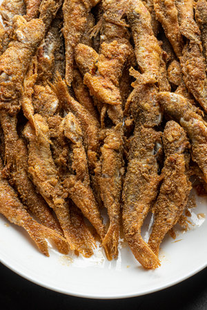 close-up detail delicious bottom fish tabby red mullet cooked in white plateの写真素材