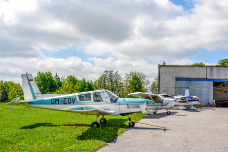 Airplanes in row, before hangar