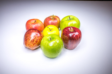 Fresh lucky seven multicolored apples painted in lightの写真素材