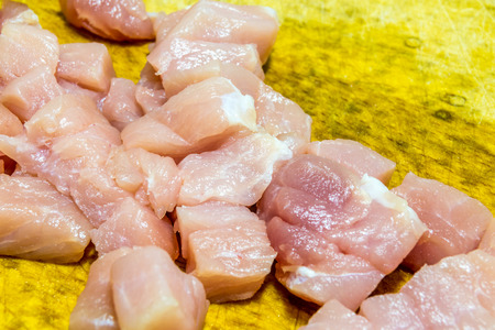 Cube pork meat on boardの写真素材