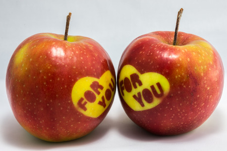 Two Valentines red applesの写真素材