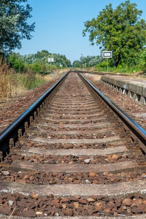 Countryside railroad track in station with platformの写真素材