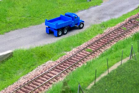 Blue scale truck on model train railroad layout roadの写真素材