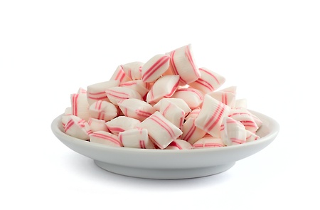 Candies in white plate on the white background.の写真素材
