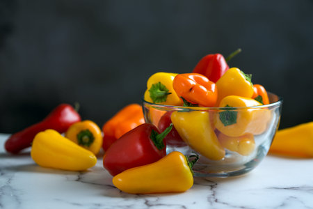 Colourful mini sweet peppers in a glass bowl