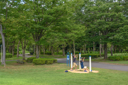 Boys playing with a iron rod in the park