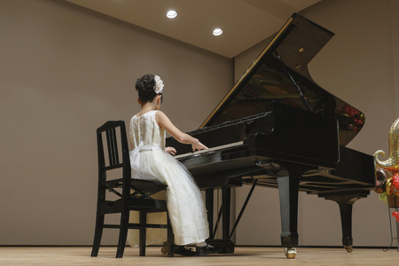 The girl who plays the piano on stageの写真素材