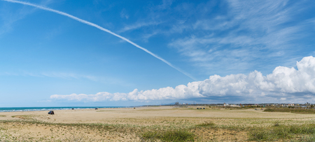 Scenery of the blue sky and sandy beachの写真素材