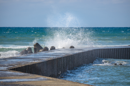 The waves beating the breakwaterの写真素材