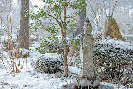 Stone Buddha Statue in snow garden