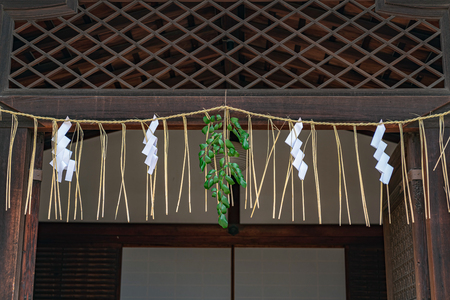 Decorated sacred straw festoon under the eaves of the Kitano Tenmangu Shrine in Kyoto, Japanのeditorial素材