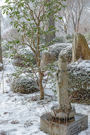 Stone Buddha Statue of snow garden in Kyotoのeditorial素材