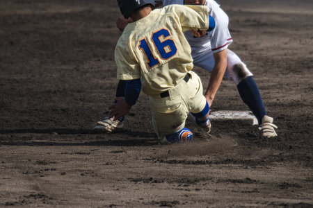 Baseball players in action at a softball game in Redding, California.の写真素材