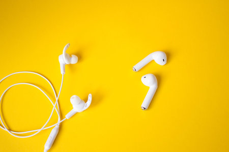 White headphones for talking and listening to music. Gadget and technology concept with copy space