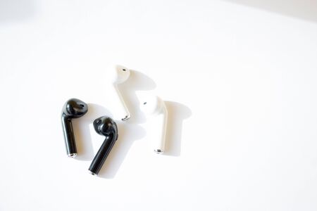 Black and white wireless headphones. Gadget and technology concept with copy spaceの写真素材