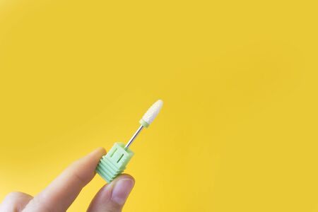 Nail Care Concept. Cutters for hardware manicure and pedicure on a yellow background.の写真素材