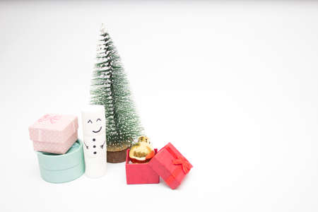 Christmas card, a snowman stands near a fluffy Christmas tree and gift box. Copy space.の写真素材
