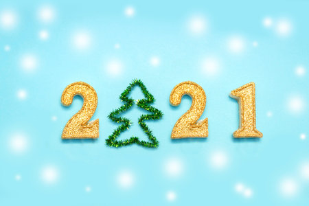Merry christmas and happy new year 2021 celebration, shiny glitter numbers on blue background.
