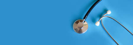 Stethoscope on blue background copy space for web. Medical internet banner.の写真素材