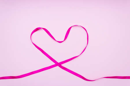 Heart made of pink ribbons on a gentle backgroundの写真素材