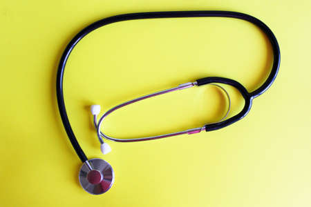 Stethoscope on a yellow background. The medicineの写真素材