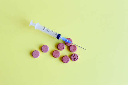 A cure for viral infection and a syringe with a vaccine.の写真素材