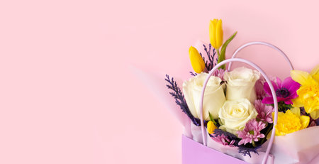 Festive flower arrangement on a pink background with copy space. Concept of the celebration....