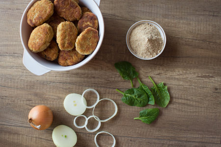 Fried beef cutlet on plate with onion and salat