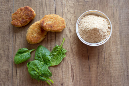 Tasty meat cutlets with green salat and hard chuckの写真素材