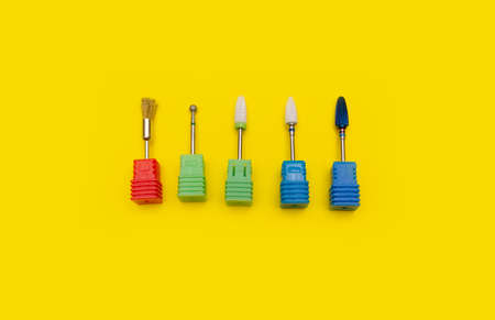 Cutters for hardware manicure. Accessories and nail tool on yellow background. Nail tool.の写真素材