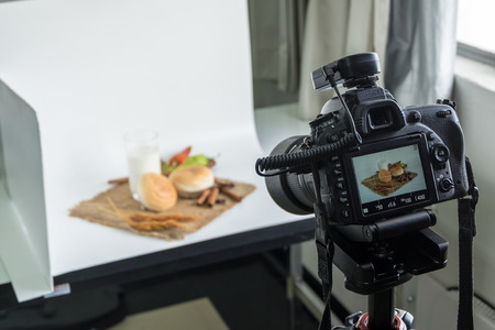 DSLR camera to shooting bread and glass of milk in  indoor photo studioの写真素材