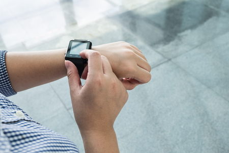Young woman using her modern smart watchesの写真素材
