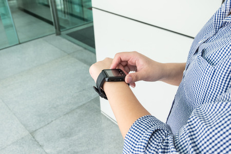 Young woman using her smart watchの写真素材