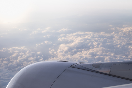Path of jet engine of airplane with clouds under sunlightの写真素材
