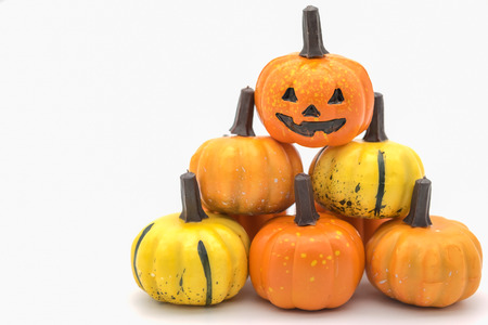 Halloween Concept.  Mini Jack o' lantern toys stack of  pumpkin on white background.の写真素材