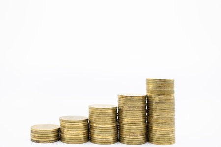 Money, Financial, Secure and saving concept. Close up of stack of used gold coins on white...